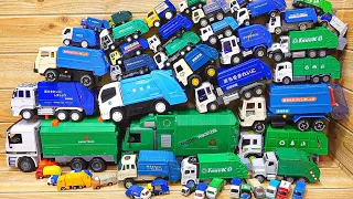 A miniature car with a large amount of blue and green garbage trucks.