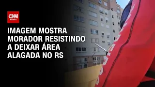 Imagem mostra morador resistindo a deixar área alagada no RS | BRASIL MEIO-DIA