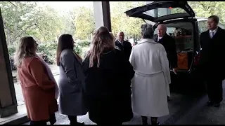 mothers daughters and granddaughters  carry her coffin into the chapel