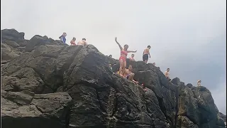 Jumping off the rocks at Waimea Bay