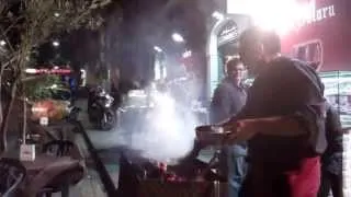 Man selling grilled horse meat near the arches  Catania 3Feb 2014