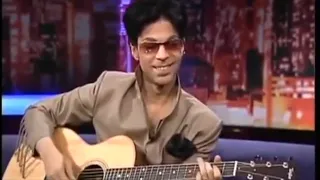 Prince playing acoustic guitar