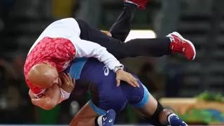 Japanese wrestler celebrates gold by slamming her coach into the ground