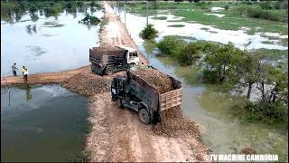 Power Machine Of Bulldozer Working Pushing Rock And Dump Truck Team Dumping Ground Into Water