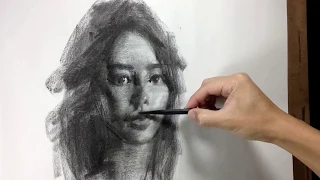 Drawing portrait in charcoal.