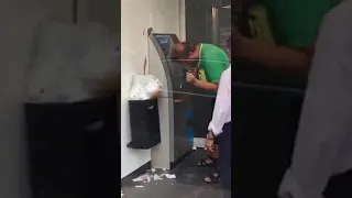 Drunk man tries to use atm/cash machine and fails miserably