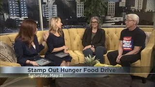 Mail carriers collecting food donations for Stamp Out Hunger Food Drive on May 11