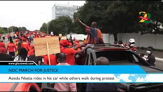 Asiedu Nketia rides in his car while others walk during protest