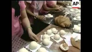 The annual Hong Kong bun race got under way with competitors attempting to scale a 30-foot bun-tower