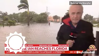 Cameraman helps people escape Hurricane Ian flooding during live coverage | AccuWeather