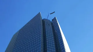 Men Tossed Around In High Winds on Skyscraper