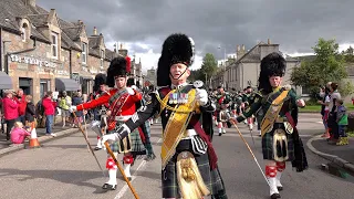 Drum Major David Rae leads the massed bands on the march after the 2019 Tomintoul Highland Games