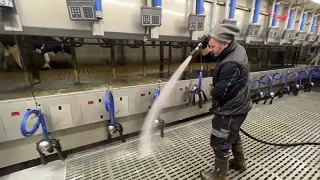 Female Farmer Cleaning Milking Cow Parlour