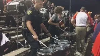 Watch Police Officer Join High School Marching Band For Impressive Drum Solo