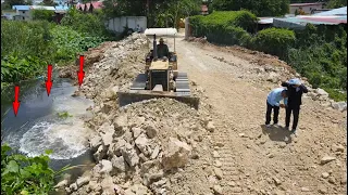 Incredible Very Good Action and power bulldozer pushing land with stone into water