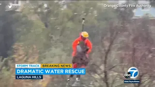 Helicopter crew rescues woman clinging to tree above fast-rising water in Orange County