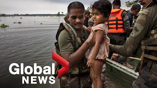 India races to rescue millions trapped by deadly floodwaters