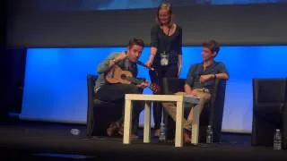 Sean Maguire sings on stage at the convention Once Upon A Time in France
