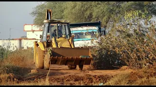 JCB Backhoe Loading Mud and Tata Tipper Unloading Mud For Canal