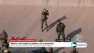 Frente a militares acampan los migrantes