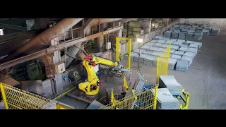 FANUC robot takes over heavy lifting and loading of two furnaces