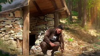 Do-it-yourself stone house. Bushcraft house in the forest