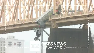 Rescuers pull driver from semi-truck dangling off bridge in Kentucky