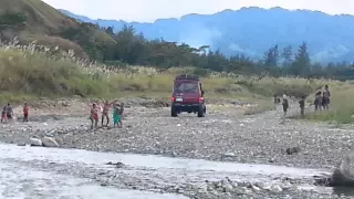 PNG Toyota Land Cruiser wet crossing.