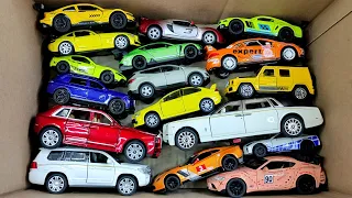 Box full of various miniature cars Peugeot, Volvo, Renault, Hyundai, Pagani, Cadillac One, DHL 01