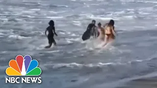 Video Captures Pro Surfer Rescuing Woman Caught In Rough Waves | NBC Nightly News