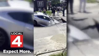 Woman’s car is engulfed by sinkhole after water main leak in SW Detroit