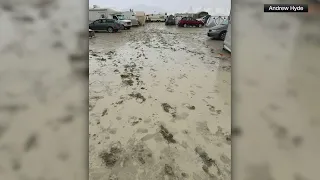 Burning Man attendees sheltering in heavy rains, mud