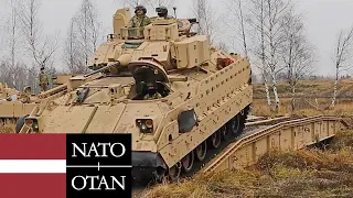 The Big Red One in Latvia. M2 Bradley armored vehicles and US Army soldiers on exercises.