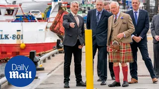 Prince Charles dons a kilt as he opens a fish market during Shetland trip