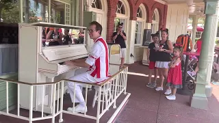 Grayson playing piano at Magic Kingdom