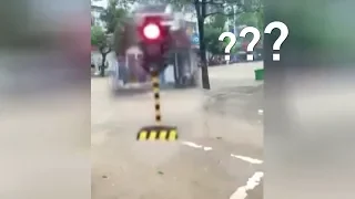 Dramatic moment: 'Walking' traffic light gets swept down the flooded street in China