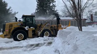 Removing snow banks in a residential neighborhood of Ottawa