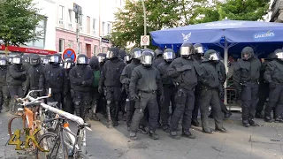 Riot police moving away while protesters chant ''Who's streets, our streets!''