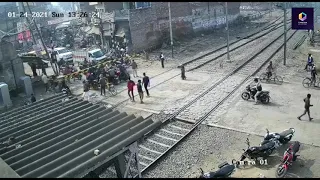 Lucky escape: Indian biker narrowly avoids being smashed by oncoming train