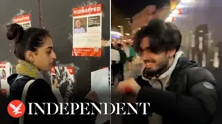 Smiling people rip down posters of kidnapped Israeli children in London's Leicester Square