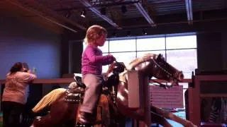 Lily rides the mechanical horse