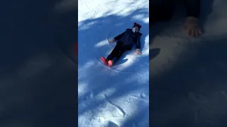 Kids and Emma making snow angels