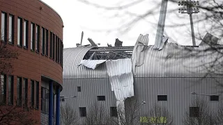 Man blowing from roof, not wise to do this in Storm Eunice Europe