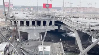 Ukrainians Cross Destroyed Bridge to Evacuate