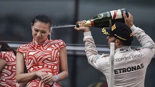 Stick a cork in it, Lewis! Formula One ace Lewis Hamilton sprays hostess girl in the face
