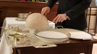 Table serving Bresse chicken cooked in a bladder ‘à la Mère Fillioux’ at 3 Michelin star Paul Bocuse