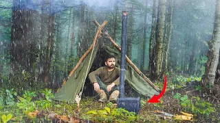 CAUGHT IN HEAVY RAIN - SOLO BUSHCRAFT, CANVAS LAVVU TENT, PORTABLE WOOD STOVE.