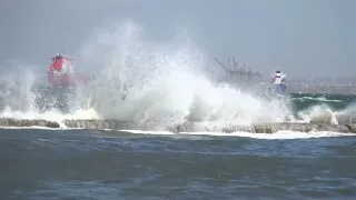 Sea wave chaser on a small breakwater with 7 Beaufort wind