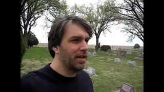 Lacy visits the graves of the Clutter family