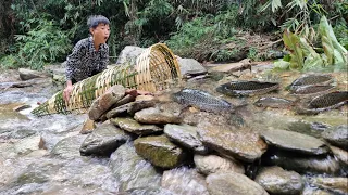 Nam's orphan boy weaves bamboo cages, blocked the streams,arranges rocks to make traps to catch fish